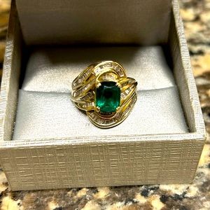 Beautiful emerald center stone, Diamond baguettes set in 10k yellow gold.